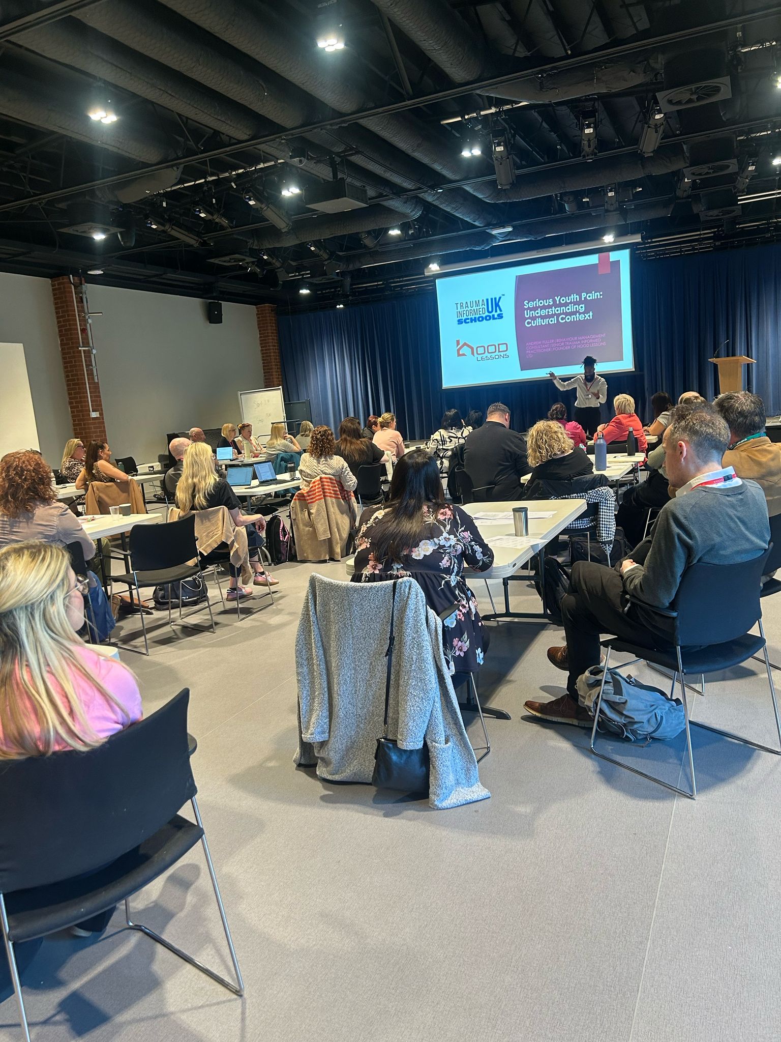 Andrew Fuller delivering a Trauma Informed Schools UK training session, "Serious Youth Pain: Understanding Cultural Context", to a room of professionals